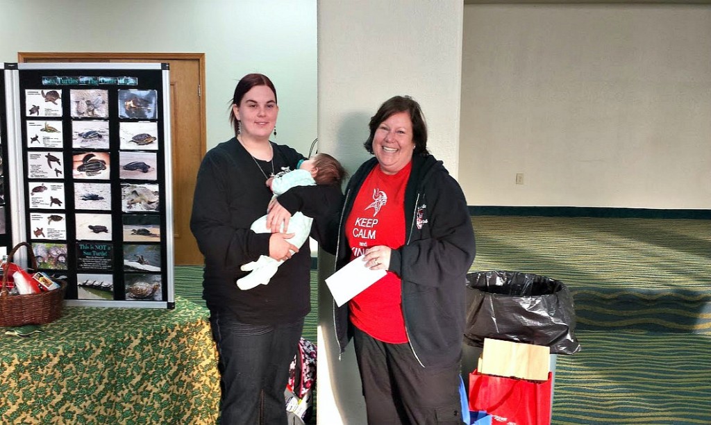 N.E.S.T. Education Chair, Elaine Lubosch accepts a donation from Stokesdale Elementary School (little baby Simone was supervising !)