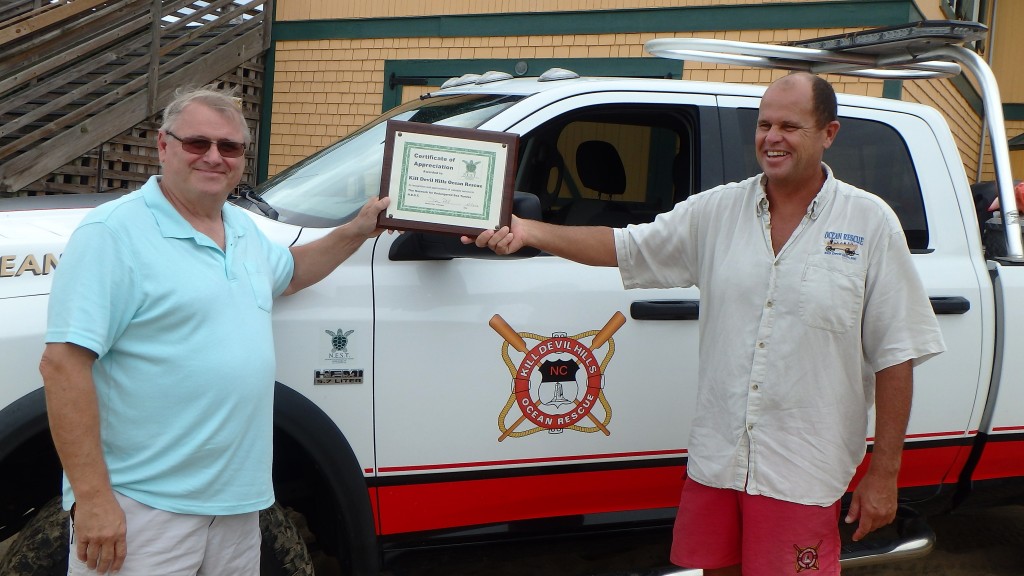 Dennis Pohl (left) N.E.S.T. presents certificate of appreciation to Supervisor Dave Elder, Kill Devil Hills Ocean rescue.