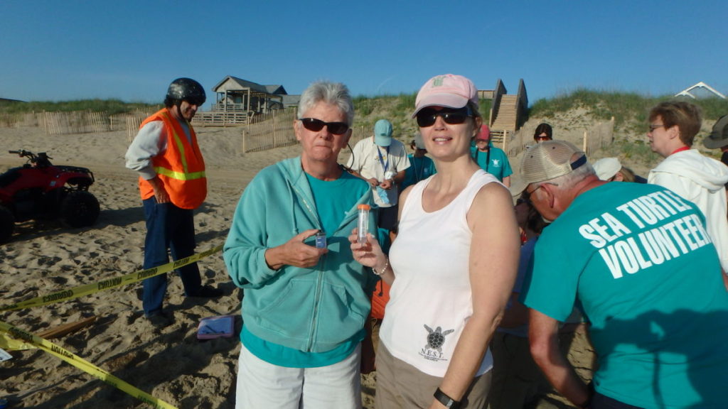 Margaret (left) holds the data logger for placement in the nest. Stephenie (right) holds the DNA egg vial at the ready.